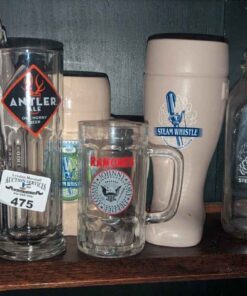 Assorted beer glasses, steam whistle jars, etc