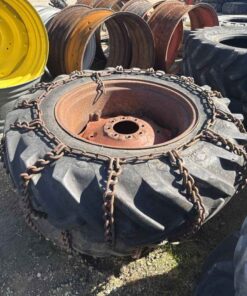 Pair of 14.9 28 tires on case 8 bolt wheels with chains