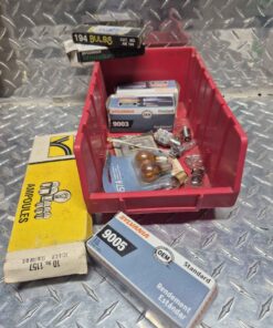 Assorted light bulbs in large red parts bin