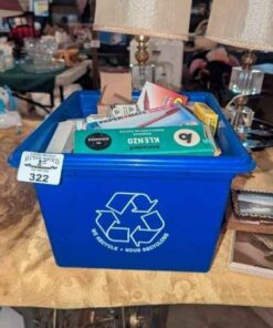 Recycle bin of labels, pens, staples, plastic tabs, etc