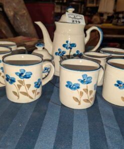 Coffee pot, cream/sugar servers and mugs
