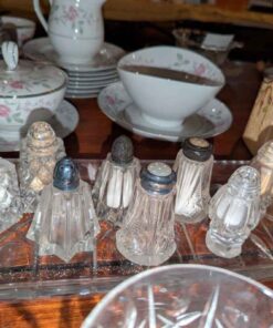 Assorted salt and pepper shakers on Thumbprint tray