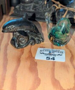 Stone dolphin carving and Kerry glass bird paperweight