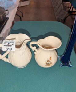 Creamers and blue glass bud vase