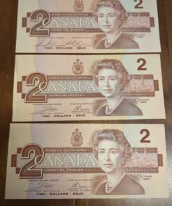 3 lightly circulated 1986 Canada 2 dollar bills.