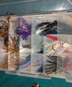 Assorted fishing jigs and plastic organizer