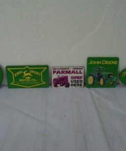 4 John Deere tool box magnets & 1 McCormick Deering Magnet