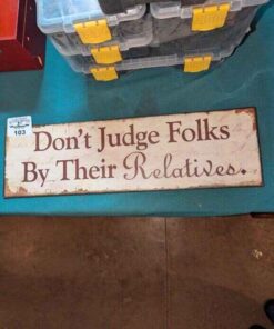 "Don't Judge Folks By their Relatives" metal wall sign