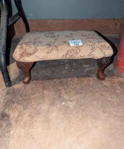 Bow legged upholstered foot stool