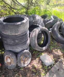 Stack of assorted size and application tires from wheelbarrow and ATV to truck some with some without rims