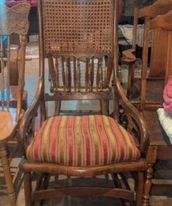 Antique cane back rocking chair with upholstered seat