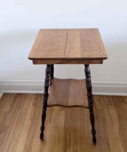 Tiered occasional table with dark turned legs and carved skirting