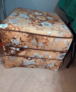 Upholstered ottoman on caster wheels