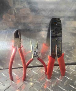 Red handled side cutters and needle nose pliers and wire strippers